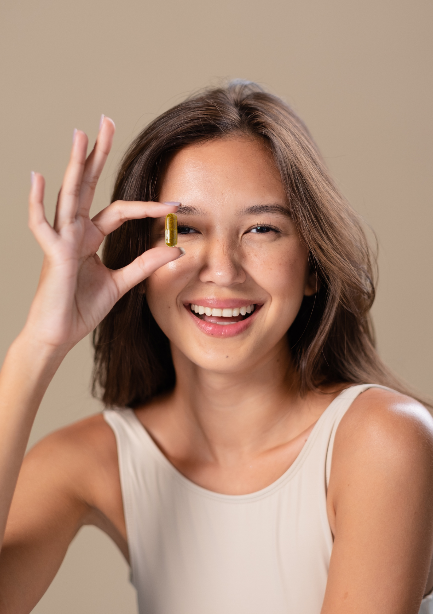Young asian women holding a dietary supplement